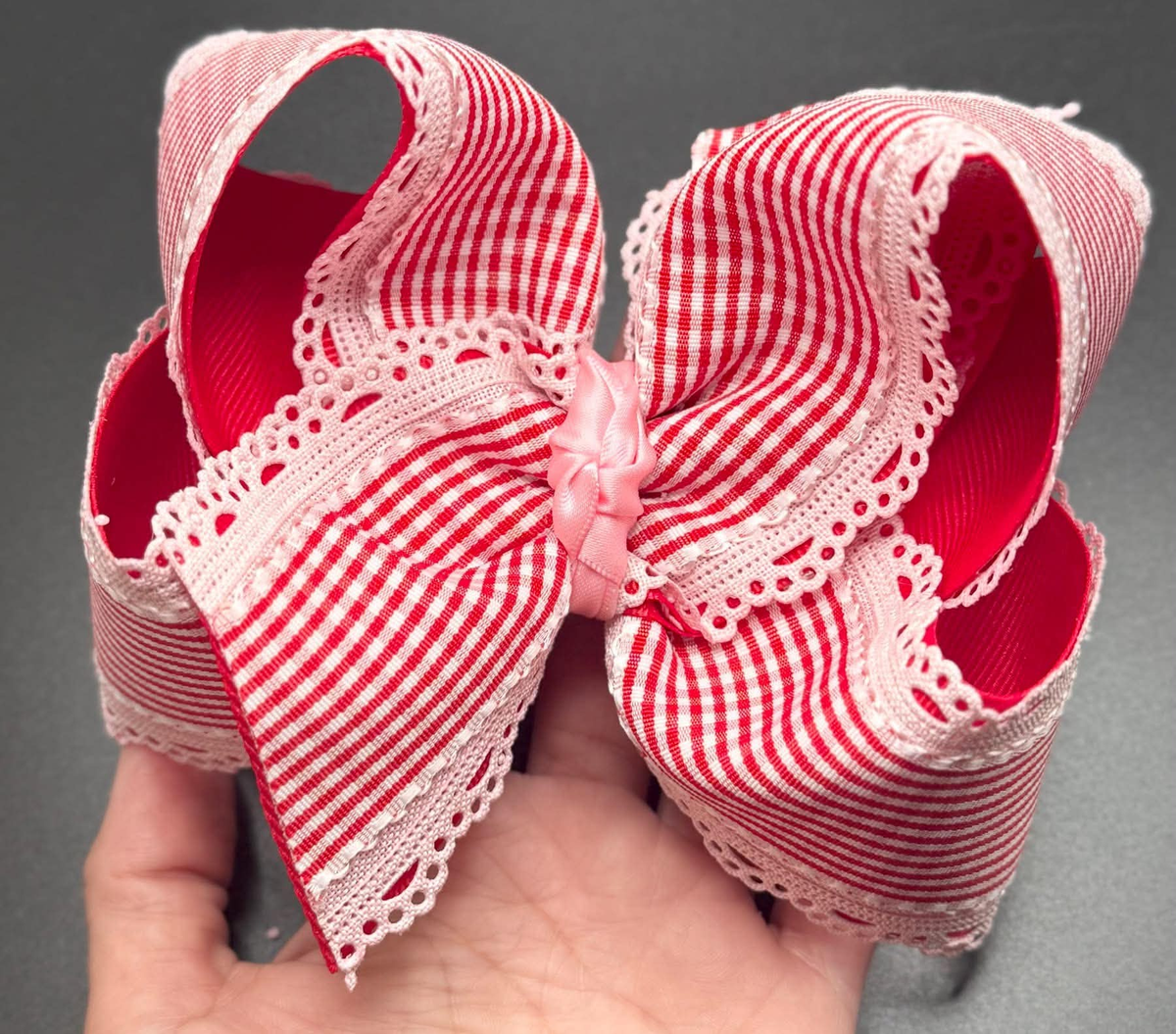 Red and white gingham bow with pink lace trim and a pink center knot